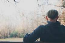 Person sitting on a bench looking at nature