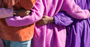 4 Ways to Make Easter Hospitality the Pattern for the Year People being welcomed while wearing coats in Easter colors