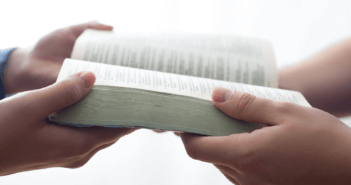 5 Purposeful Practices to Foster Shared Leadership Passing a Bible from one person to another